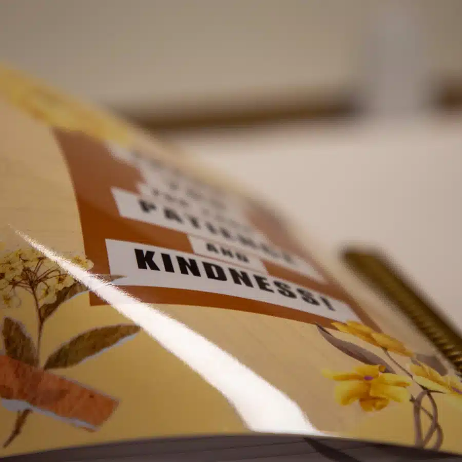 Notebook with floral design and positive message.