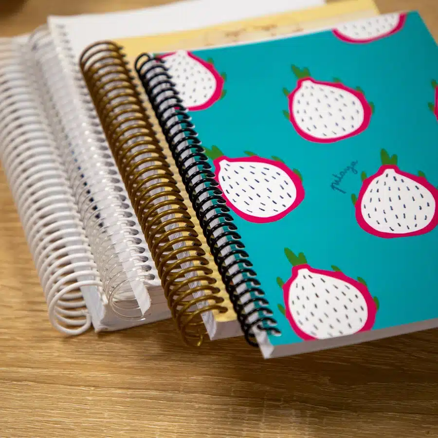 Colorful spiral notebooks on wooden desk