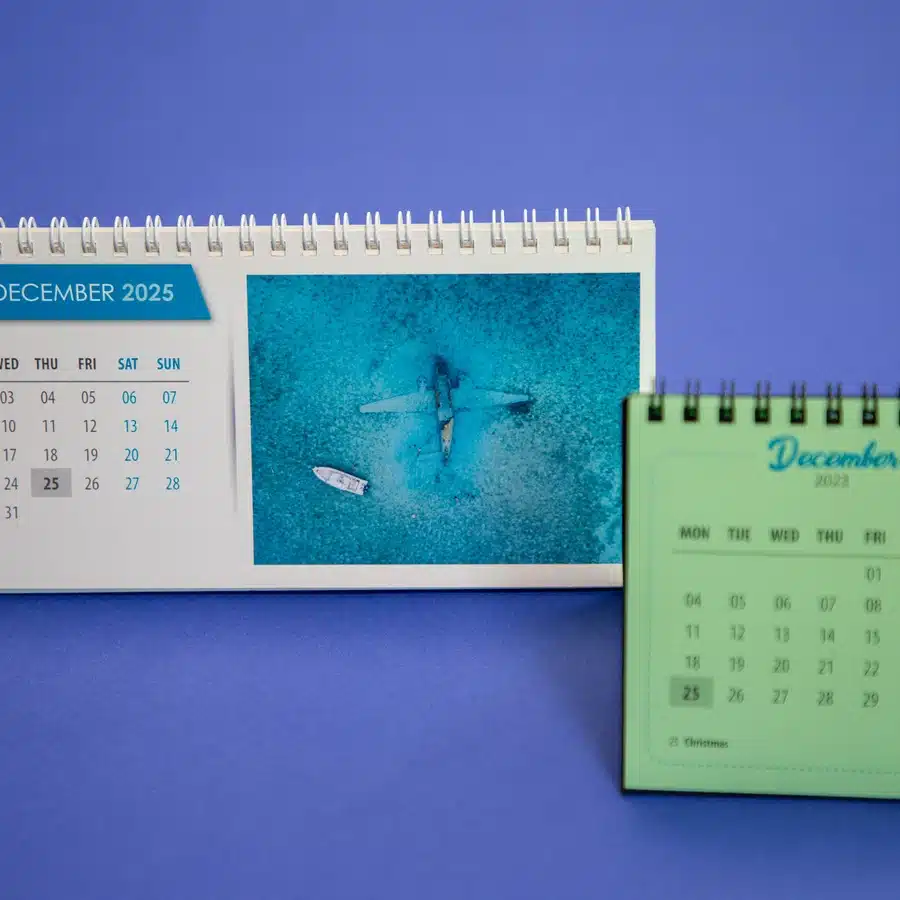 Two December calendars and aerial beach photo.